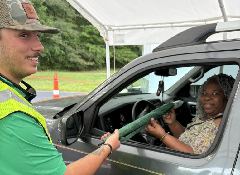 Member being welcomed to drive-thru registration